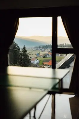 a view of a window with a book on a table at Villa Bosanska Zvijezda in Vlasic