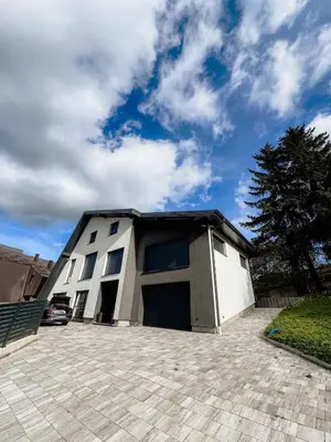 a building with a car parked in a parking lot at Villa Bosanska Zvijezda in Vlasic