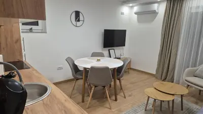 a living room with a white table and chairs at Bella Vacanza Apartment in Banja Luka