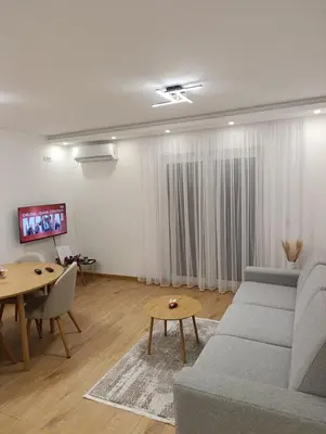 a living room with a couch and a table at Bella Vacanza Apartment in Banja Luka