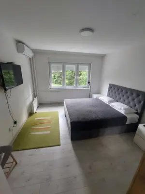 a bedroom with a bed and a green rug at Index 1 in Hiseti