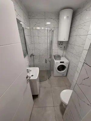 a bathroom with a shower and a toilet and a sink at Index 1 in Hiseti