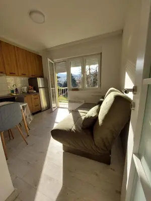 a living room with a couch and a kitchen at Index 1 in Hiseti