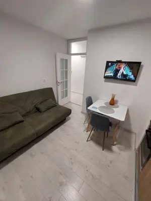 a living room with a couch and a table at Index 1 in Hiseti