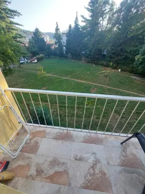 a metal railing on a balcony with a field at Index 1 in Hiseti