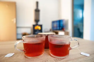 two cups of tea sitting on top of a table at Apartmani Biser Kupresa 1 in Kupres