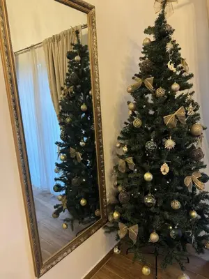 a christmas tree in front of a mirror at Country House Lištani-renta quad in Livno