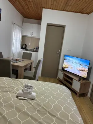 a bedroom with a bed and a flat screen tv at Apartman Biser Kupresa 3 in Kupres