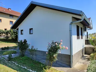 a white garage with a black roof at Perfect Serene Escape in Kuljani