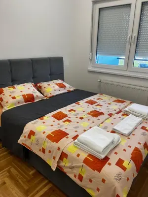 a bedroom with two beds with a comforter at Apartman Sofija Banja Luka in Banja Luka