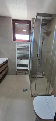 a bathroom with a shower and a toilet at Center Heritage Apartment in Teslić