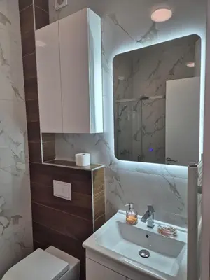 a bathroom with a white sink and a mirror at Apartman Sto in Banja Luka