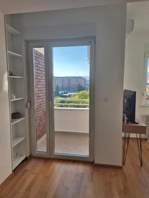 a room with a sliding glass door with a view at Apartman Sto in Banja Luka