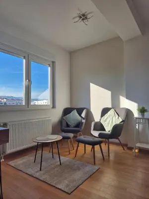 a living room with two chairs and a table at Apartman Sto in Banja Luka