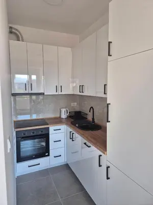 a kitchen with white cabinets and a sink at Apartman Sto in Banja Luka