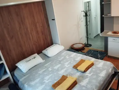 a room with a bed with two towels on it at Apartman Dunja Doboj in Doboj