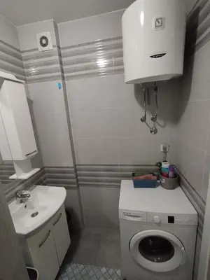 a small bathroom with a toilet and a sink at Apartman Dunja Doboj in Doboj