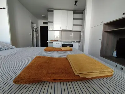 a bedroom with two brown towels on a bed at Apartman Dunja Doboj in Doboj