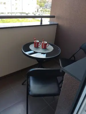 two coffee mugs sitting on a table in a room at Apartman Dunja Doboj in Doboj