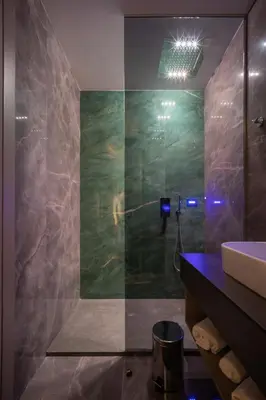 a bathroom with a sink and a glass shower at Luxury Apartments Palata - Stan Infinity in Banja Luka