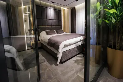 a bedroom with a bed and a glass door at Luxury Apartments Palata - Stan Infinity in Banja Luka