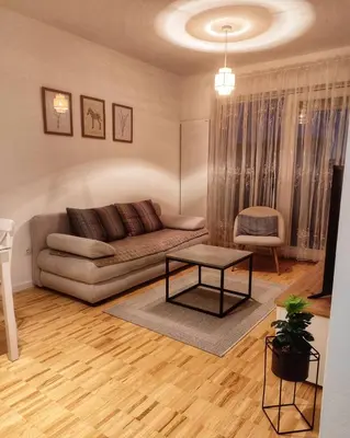 a living room with a couch and a table at Apartman Panić in Bosanska Gradiška