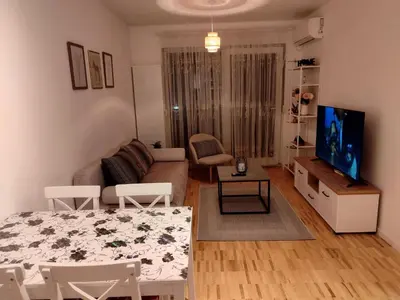 a living room with a couch and a table and a tv at Apartman Panić in Bosanska Gradiška