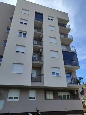 a tall white building with balconies on it at Apartman Panić in Bosanska Gradiška