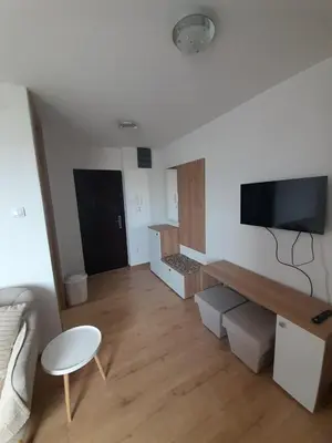 a living room with a couch and a tv on the wall at stan san banjaluka in Banja Luka