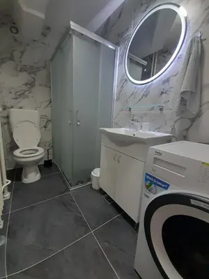 a bathroom with a sink and a toilet and a mirror at stan san banjaluka in Banja Luka