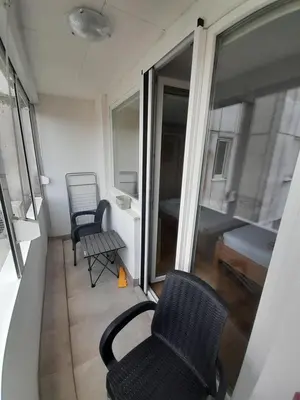 a room with two chairs and a window and a bed at stan san banjaluka in Banja Luka