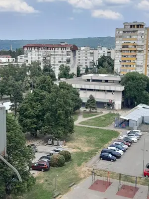 a parking lot with cars parked in a city at stan san banjaluka in Banja Luka