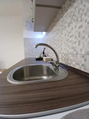 a kitchen sink with a faucet on top of it at Silencio in Banja Luka