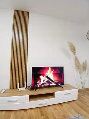 a flat screen tv sitting on top of a entertainment center at Silencio in Banja Luka