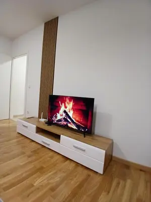 a flat screen tv sitting on a stand in a living room at Silencio in Banja Luka