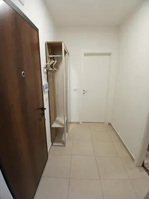 a hallway with a door and a tiled floor at Silencio in Banja Luka