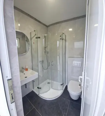 a bathroom with a shower and a toilet and a sink at Kuća za odmor 