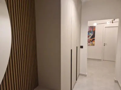 a hallway with white walls and a painting on the wall at Kuća za odmor 