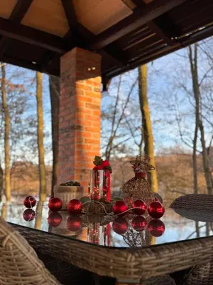 a table with red candlesticks on top at Vikendica Šššuma in Srbac