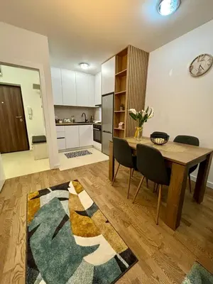 a kitchen and dining room with a table and chairs at Apartman Leo in Banja Luka