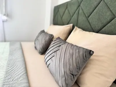 a bed with two pillows on top of it at Apartman Leo in Banja Luka