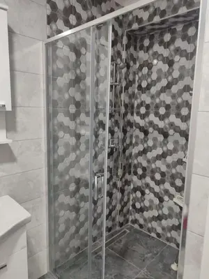 a shower with a glass door in a bathroom at Apartman Munir Zahirovič in Travnik