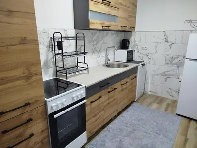 a kitchen with a stove and a sink at Apartman Munir Zahirovič in Travnik