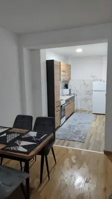 a kitchen with a table and chairs in a room at Apartman Munir Zahirovič in Travnik