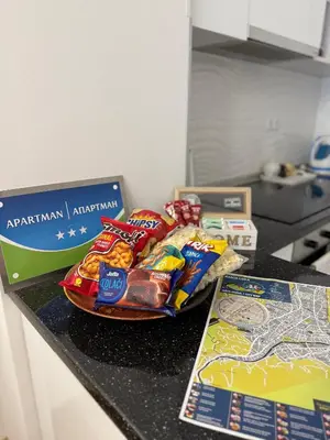 a counter top with a bunch of snacks on it at Apartman Bonaca in Banja Luka