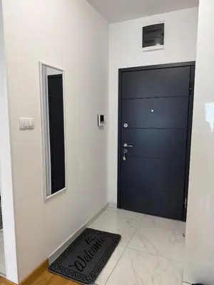 a black door in a room with a mirror at Apartman Bonaca in Banja Luka