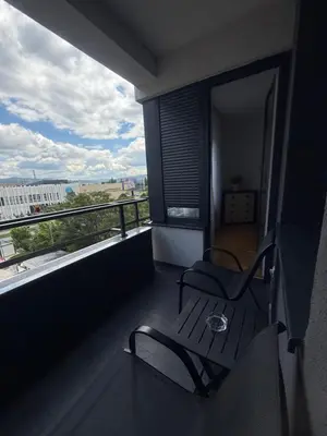 a balcony with two chairs and a view of a city at Apartman Bonaca in Banja Luka