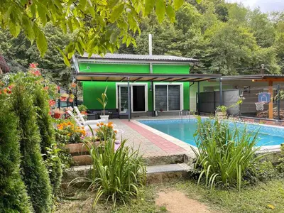 a house with a swimming pool in a yard at Holiday cottage-vikendica in Donji Podovi