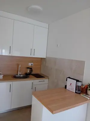 a kitchen with white cabinets and a sink at Apartman Milan'o in Doboj