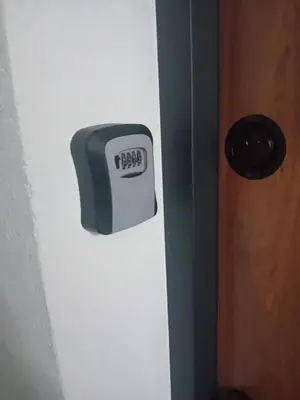 a clock on the side of a door at Apartman Milan'o in Doboj